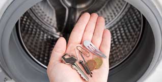 Check pockets for coins, pins, and small objects
